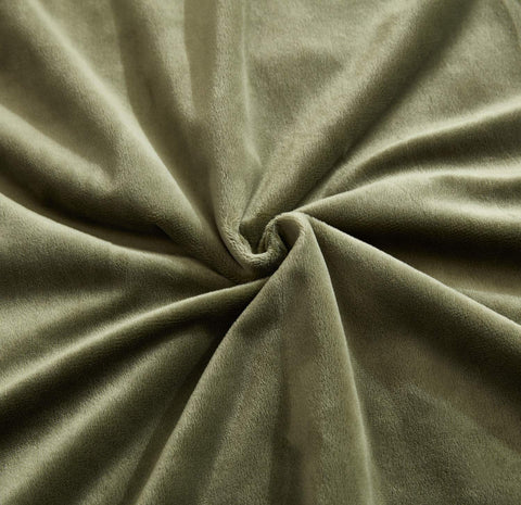 Hobed Life blanket layered on bed for decorative and cozy effect