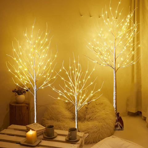 HOLILLUMA front view of three lighted birch trees adding warm glow