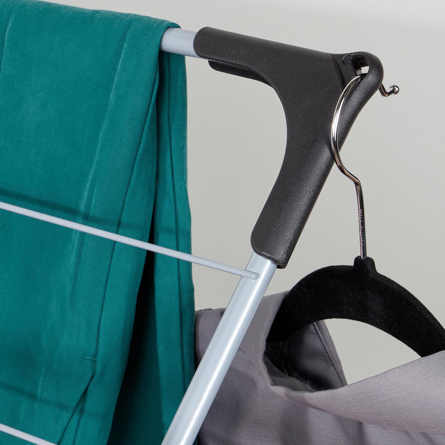 Home Basics folded rack stored next to washer showing compact, space-saving design