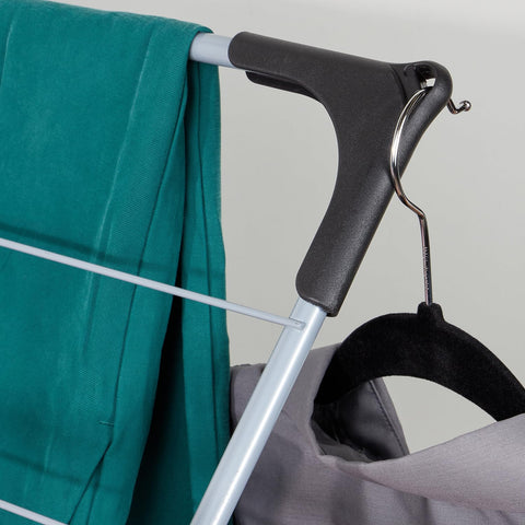 Home Basics folded rack stored next to washer showing compact, space-saving design