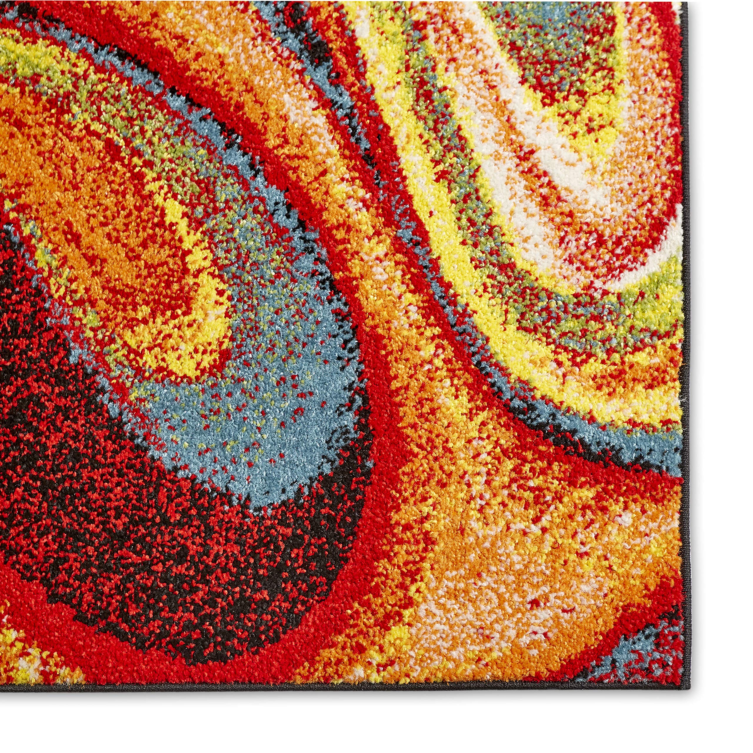 Home Dynamix rug beside sofa illustrating 5'2" x 7'2" scale and fit