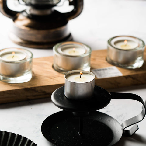 Home Lights hand holding a tealight to show compact scale