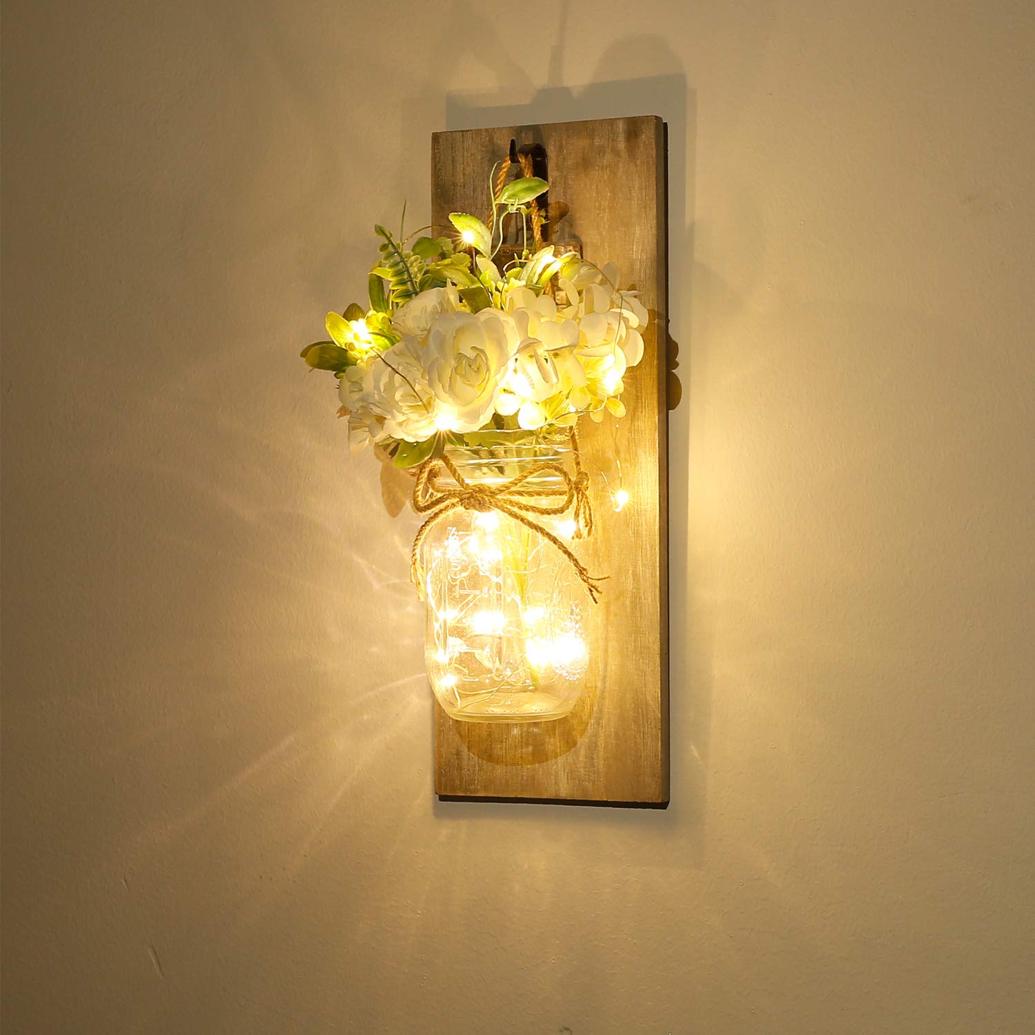 Homecor close-up of glass mason jar highlighting LED fairy lights and floral detail