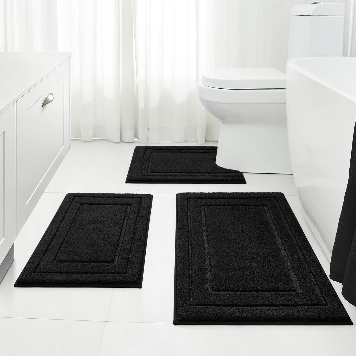 HOMEIDEAS front view of three black bath mats showing coordinated set and comfort