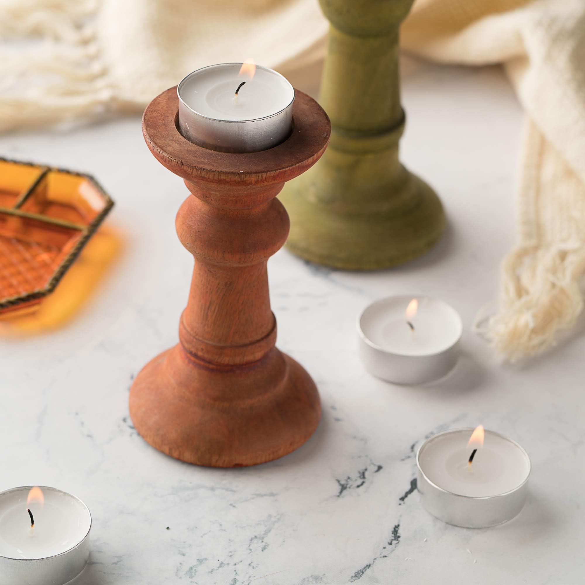 Home Lights tealights decorating a party table, creating cozy atmosphere