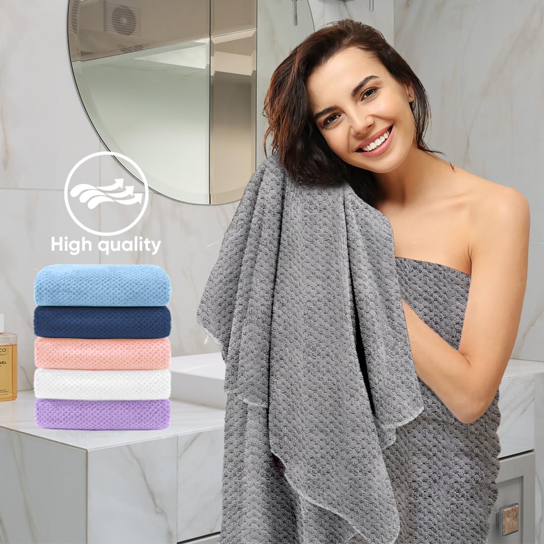 HOMEXCEL towel beside a hand to show scale and travel-friendly size benefit