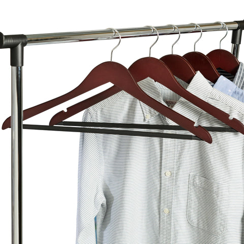 Honey-Can-Do hanger next to hand for size comparison showing slim-profile storage