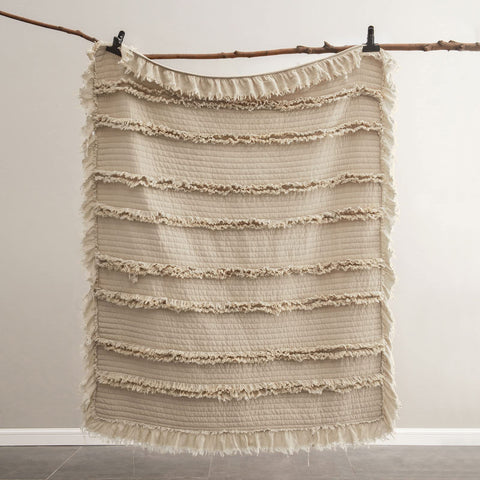 HORIMOTE HOME folded blanket beside a book showing compact scale