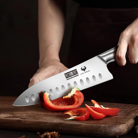 HOSHANHO knife next to hand for scale illustrating the compact 7" versatile size