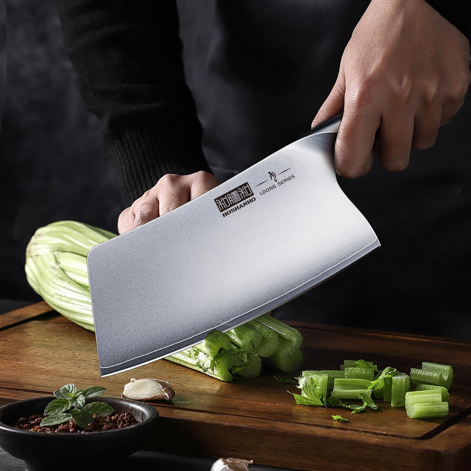 HOSHANHO cleaver portioning meat demonstrating durable forged steel strength