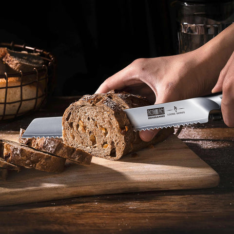HOSHANHO knife next to hand showing 10-inch scale for size and handling clarity