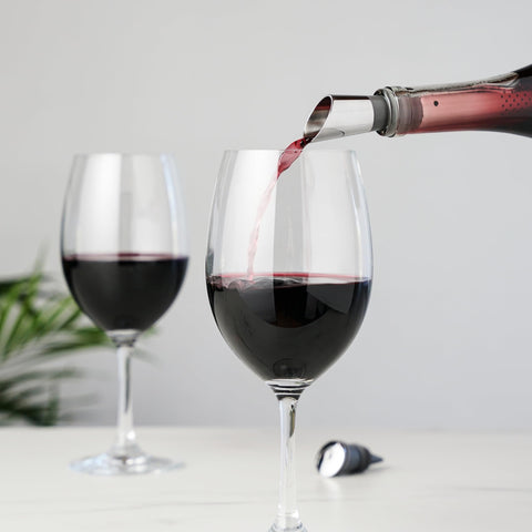 Host pouring from bottle with spout to demonstrate controlled aeration benefit