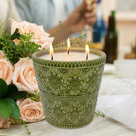 HOSVOT lit candle on a patio creating relaxing atmosphere and insect-reducing benefit