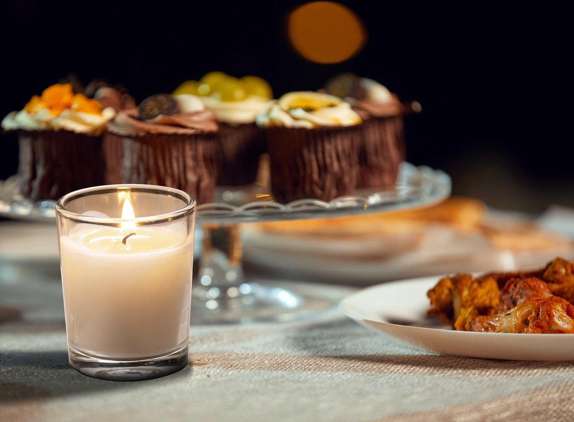 Housecret lit votive in clear holder creating soft neutral ambiance
