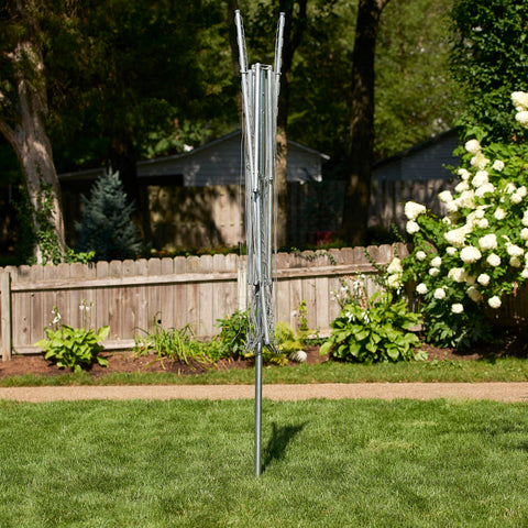 Household Essentials umbrella dryer assembled in yard showing large outdoor drying area