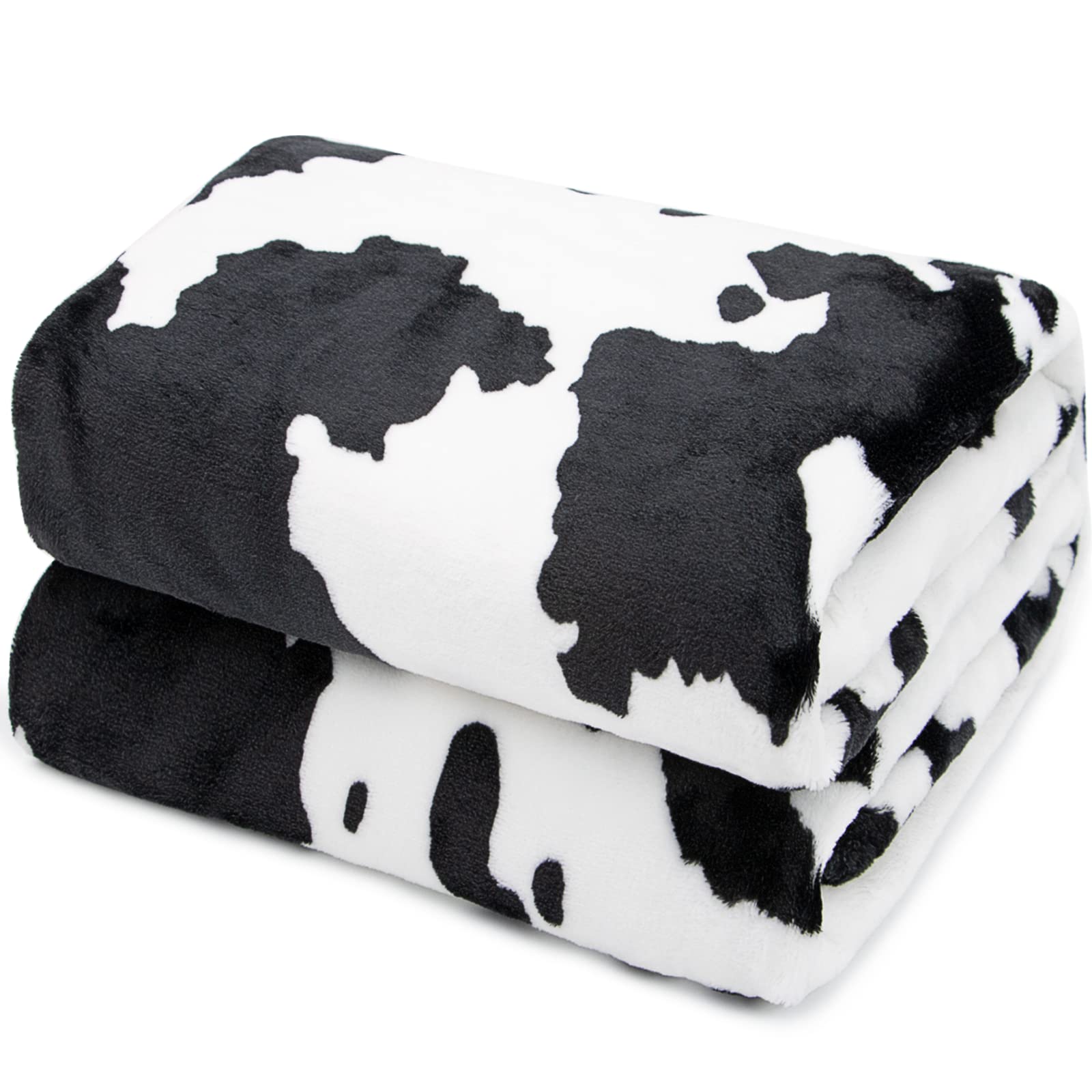 HSEEC cow blanket on a twin bed showing coverage and decor impact