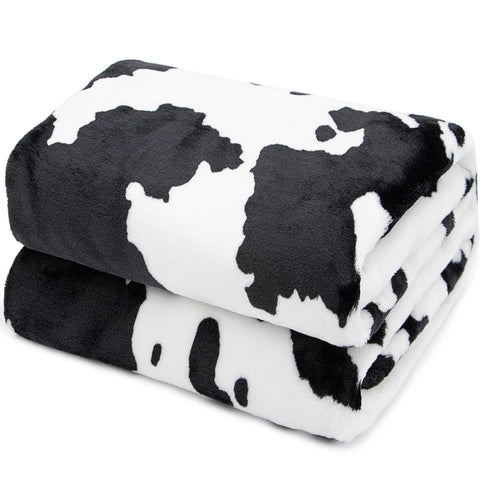 HSEEC cow blanket on a twin bed showing coverage and decor impact