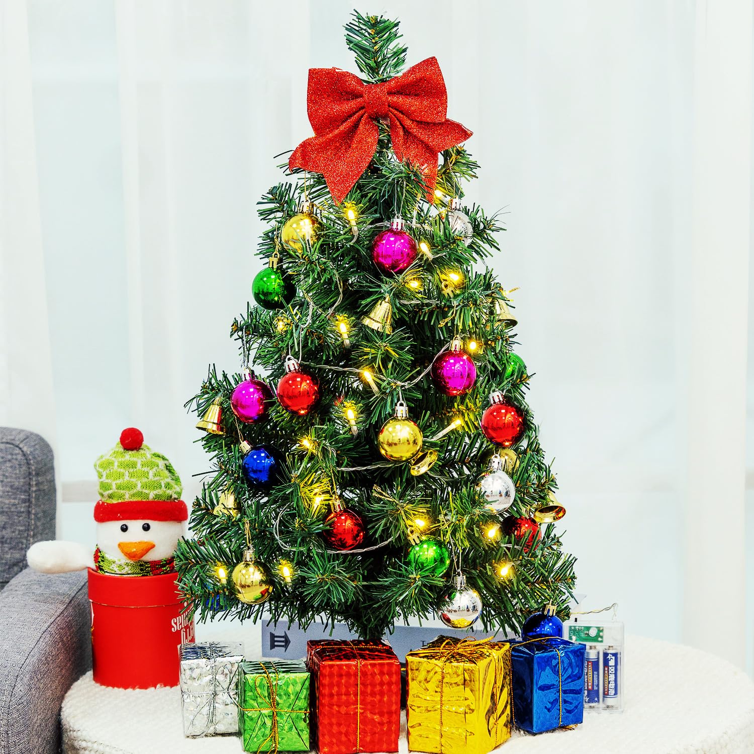 HUAERYOUYUE tabletop tree styled on a side table to add instant holiday ambiance