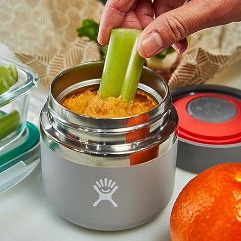 Hydro Flask food jar next to backpack showing suitability for commuting and hiking
