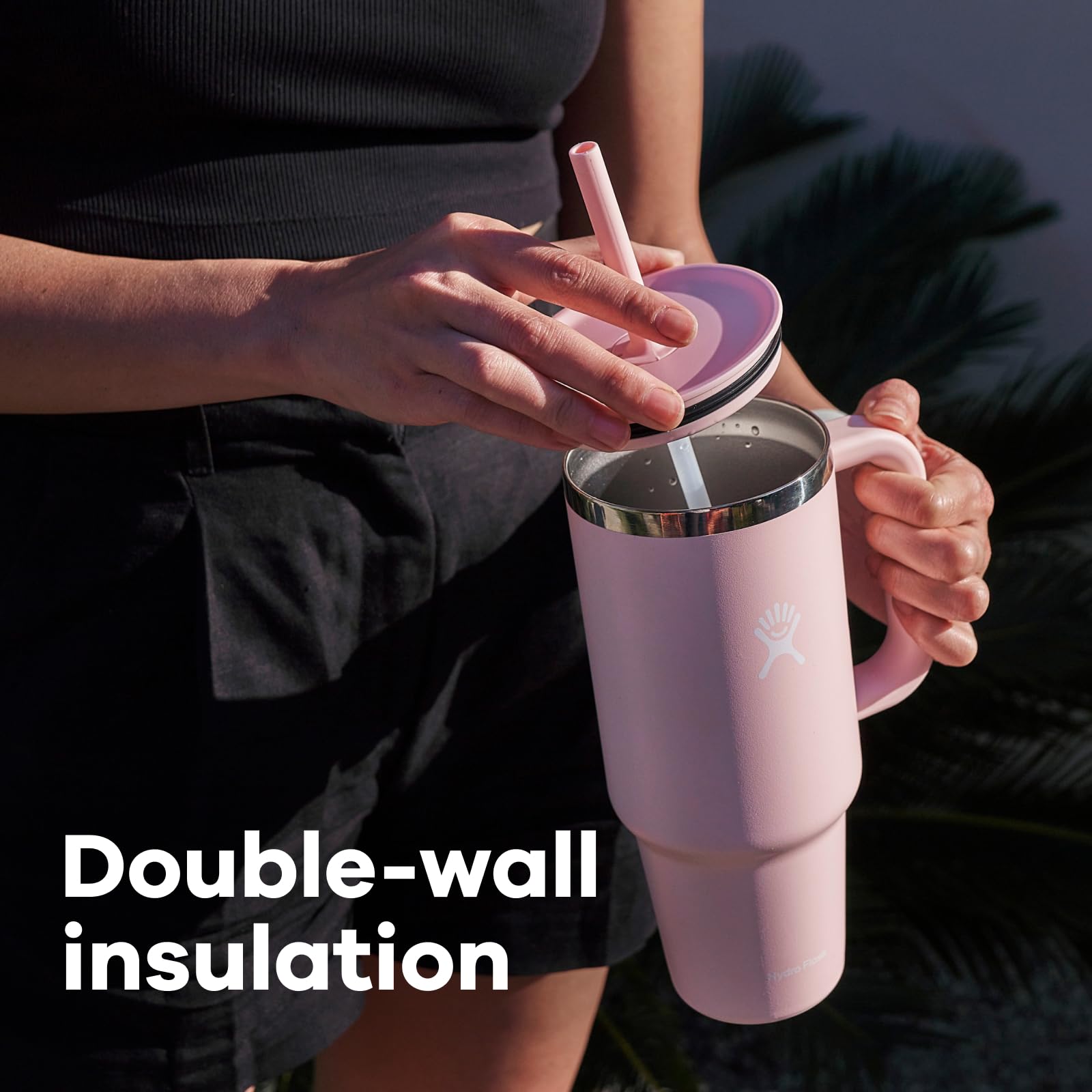 Hydro Flask tumbler held by hand for scale, showing comfortable 32 oz capacity