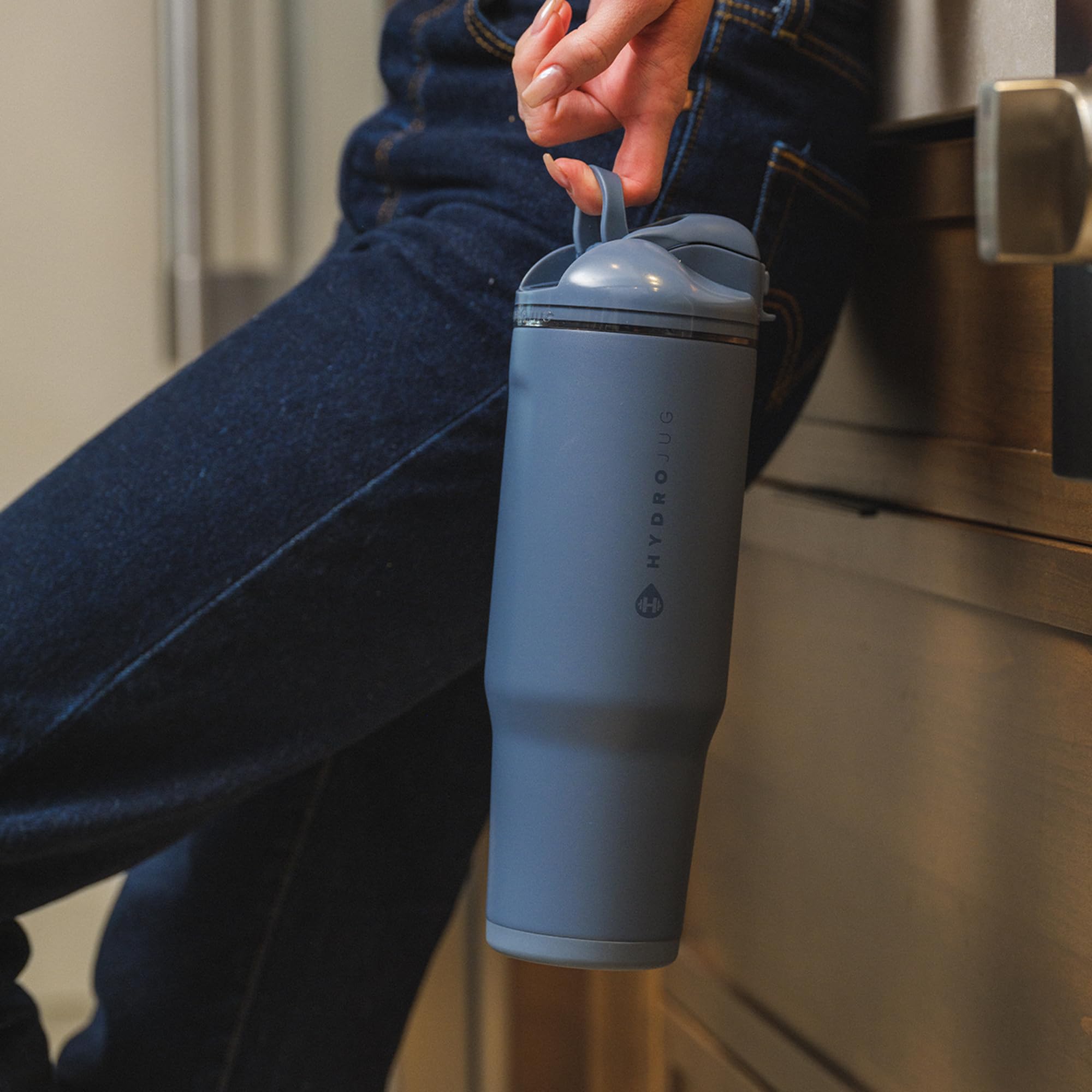 HydroJug lifestyle outdoors illustrating portability and cold retention benefit