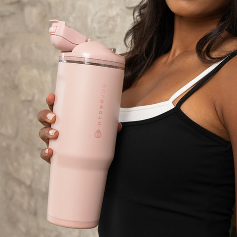 HydroJug Ease2o beside hand to show 40oz scale for daily hydration planning