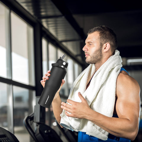 HYDROWION bottle on beach towel, durable and portable for outdoor adventures
