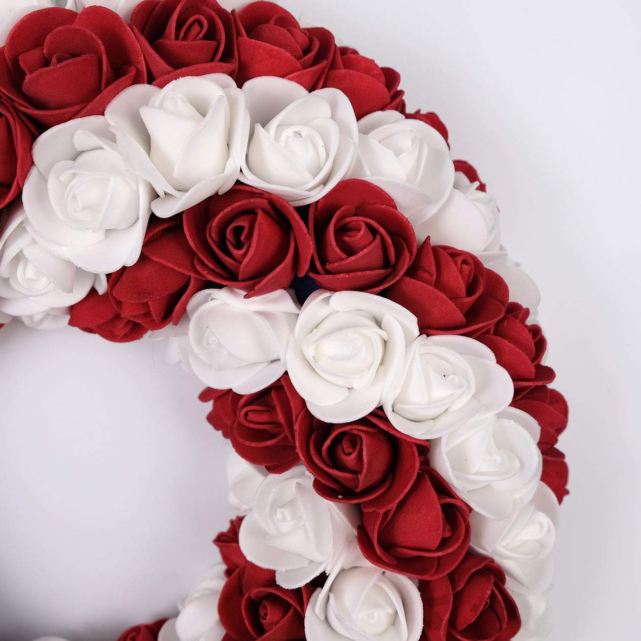 idyllic wreath held in hand showing 13-inch scale and easy-hang benefit