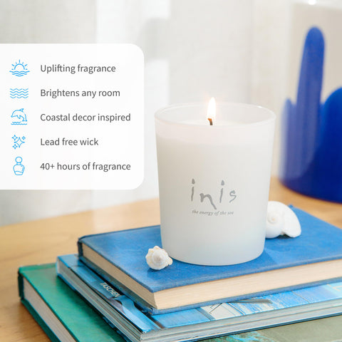 Inis candle beside a mug to show scale and suggest long 40+ hour burn time