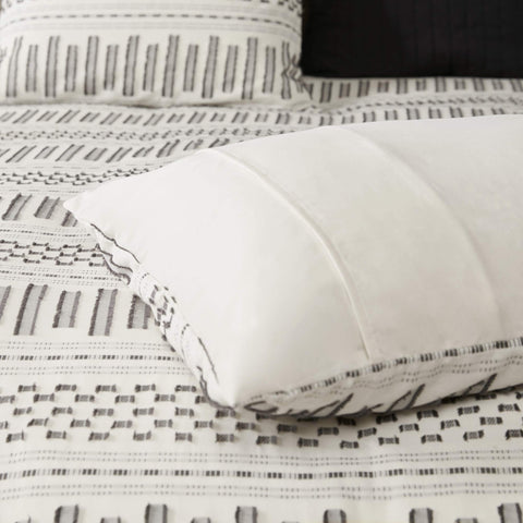 INK+IVY folded comforter in lifestyle scene showing easy layering and neutral tones