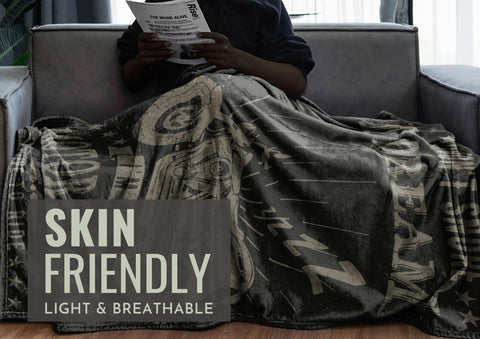 InnoBeta blanket draped on sofa demonstrating warmth and stylish home use