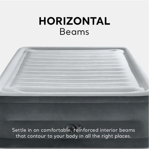 Intex mattress next to chair for scale and room placement clarity