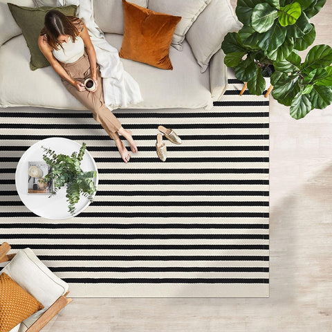 IOHOUZE rolled rug beside tape measure to show true 4x6 scale and coverage
