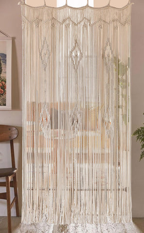IOWER macrame curtain hung in a sunlit window, softens light and creates warm ambiance