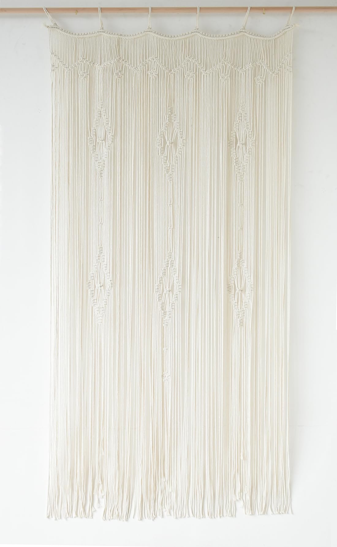 IOWER macrame curtain in a styled bedroom setting, enhances decor with natural texture