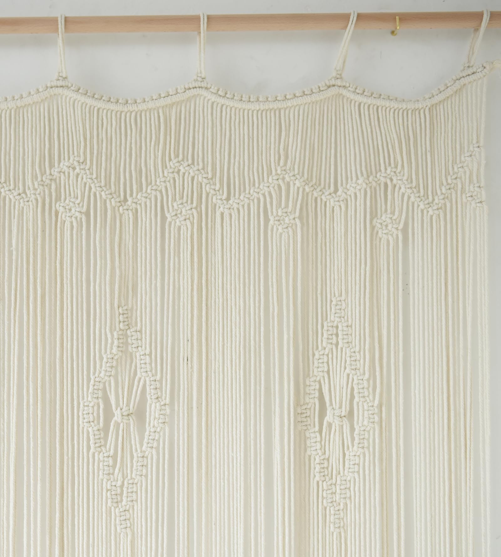IOWER macrame curtain used as room divider between living spaces, defines zones beautifully