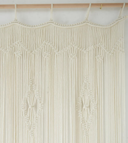 IOWER macrame curtain used as room divider between living spaces, defines zones beautifully