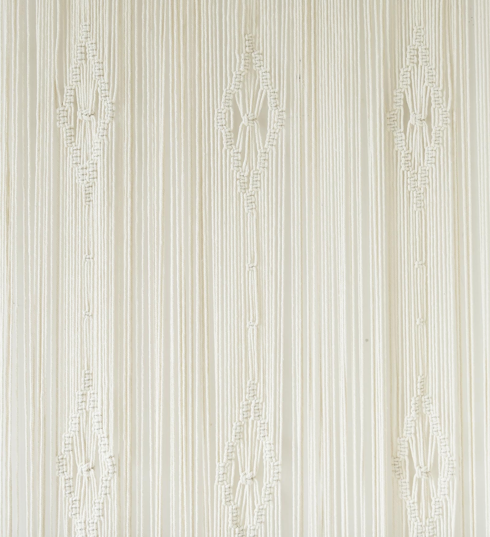 IOWER macrame curtain next to a chair for size comparison, shows accurate 35x70 inch scale