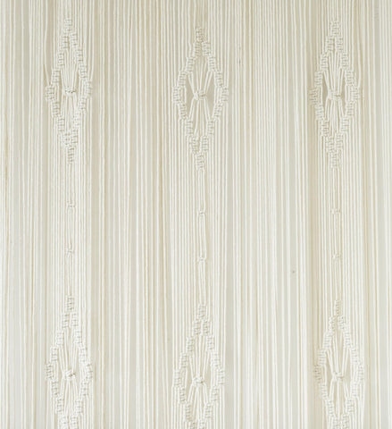 IOWER macrame curtain next to a chair for size comparison, shows accurate 35x70 inch scale