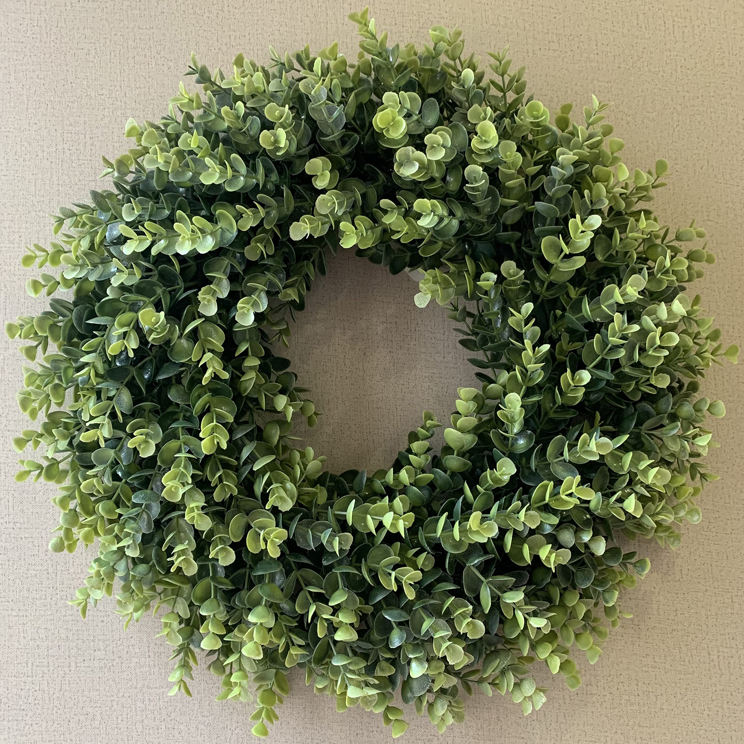 IPLNTS wreath hung on fireplace mantel adding year-round greenery and cozy style