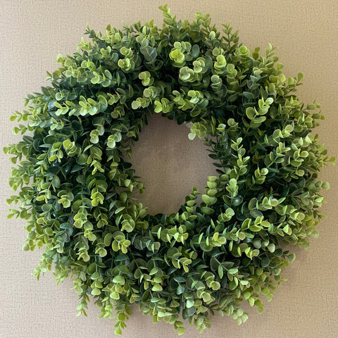 IPLNTS wreath hung on fireplace mantel adding year-round greenery and cozy style
