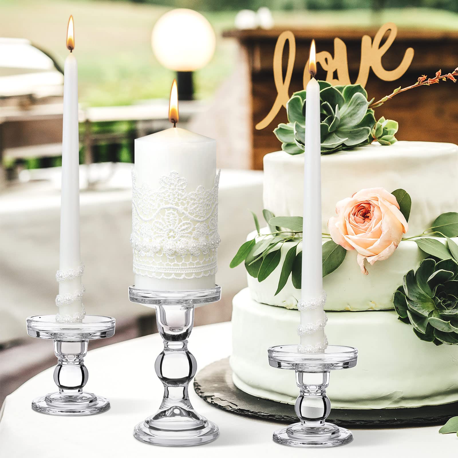 Irenare styled table centerpiece with candles adding warm ambiance at a wedding