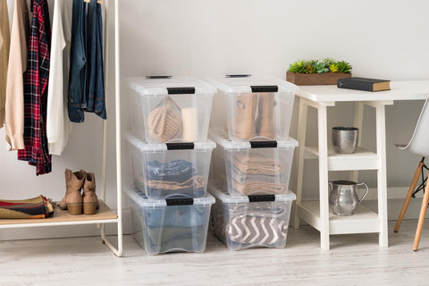 IRIS USA clear bin filled with folded clothes showing quick identification benefit