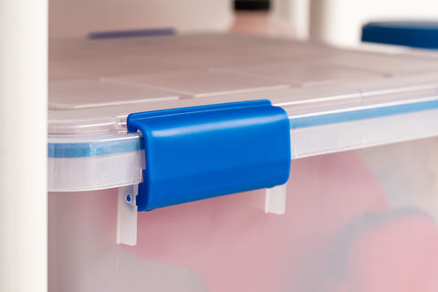IRIS USA bin held in hand showing 44 qt scale and portability