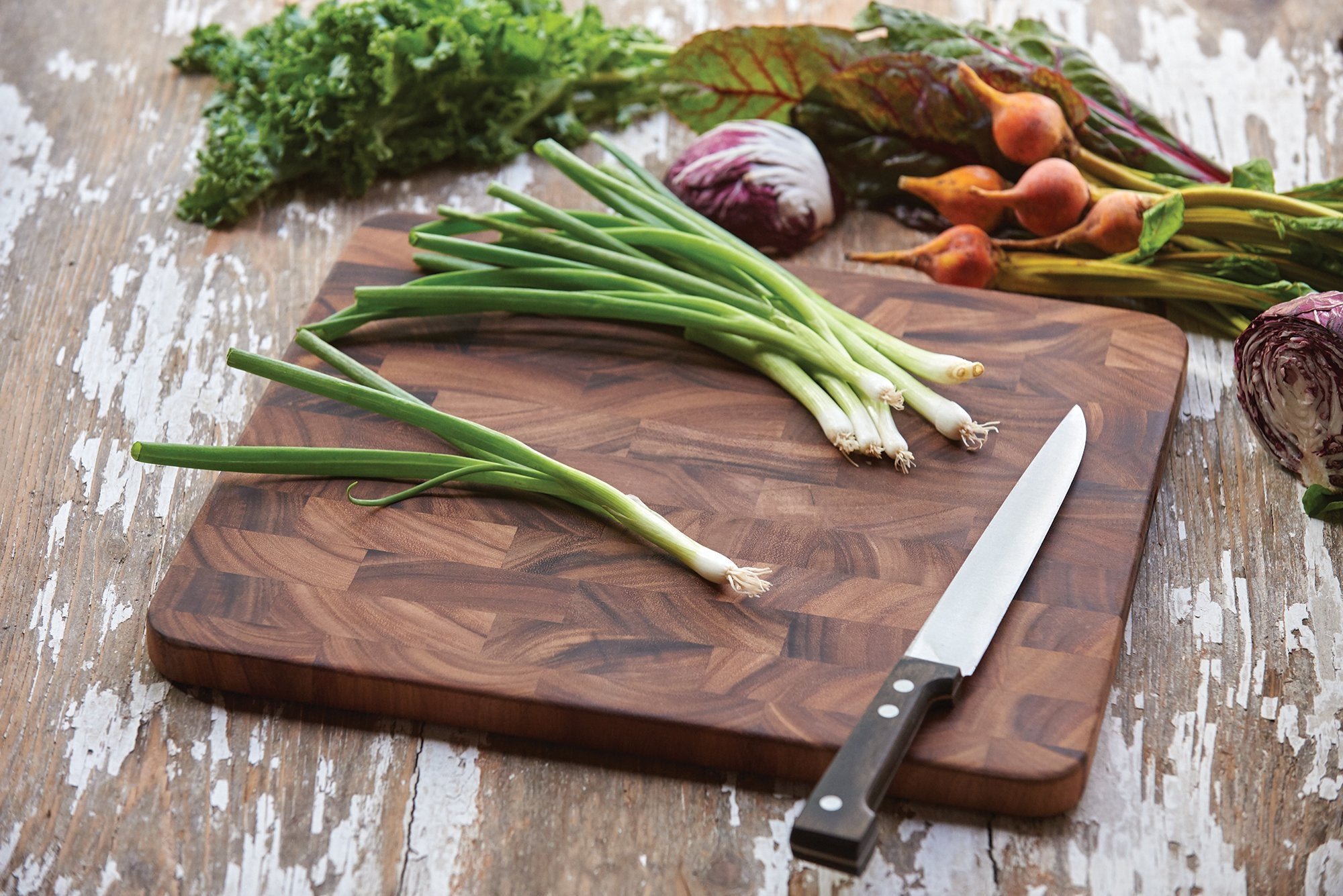 Ironwood Gourmet board in use chopping vegetables showing stable prep surface and protective benefit