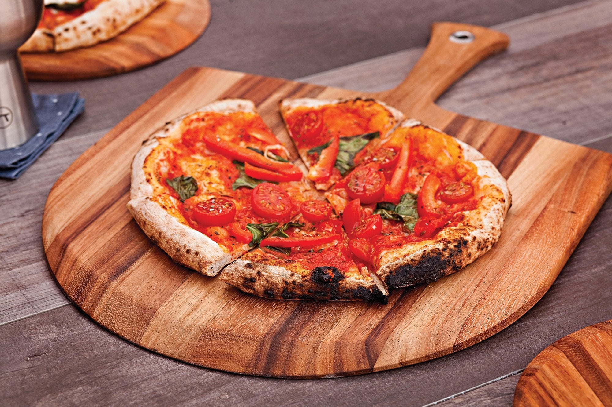 Ironwood Gourmet next to a baked pizza showing scale and generous 14x20 size