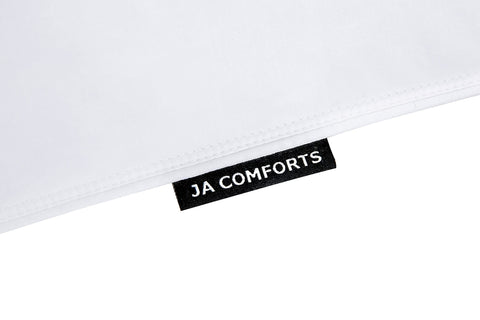 JA COMFORTS pillows on a made bed demonstrating elevated sleep comfort