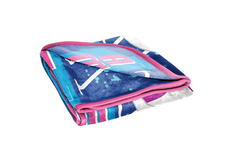 Jay Franco folded blanket beside a backpack showing compact travel-friendly size