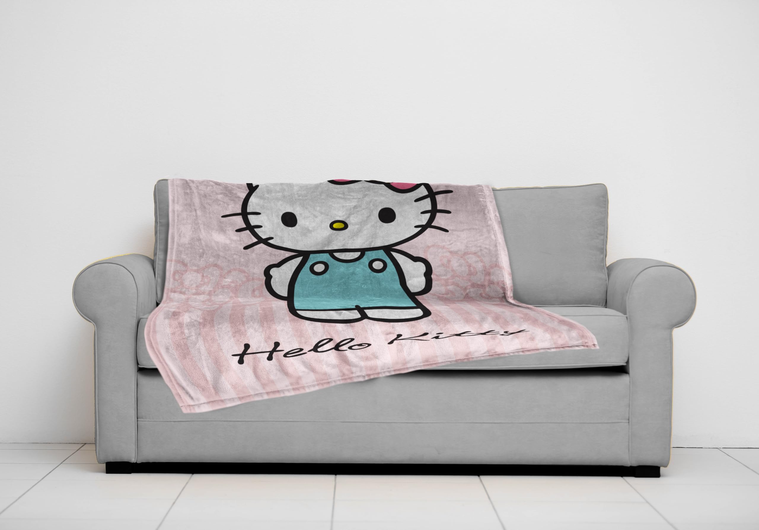 Jay Franco Hello Kitty throw next to ruler showing 50x70 inch size clarity