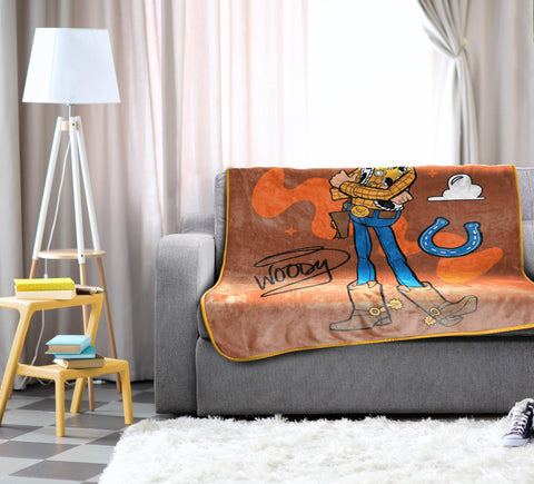 Jay Franco Woody draped on bed adding playful Toy Story charm and cozy warmth